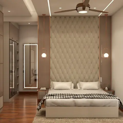 Master bedroom with a diamond-tufted upholstered headboard wall flanked by rose-gold-trimmed pendant lights and a mirrored sliding wardrobe.