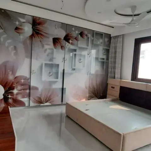 Master bedroom with a floor-to-ceiling digital-printed floral wardrobe, a wood-and-upholstered bed with integrated nightstands