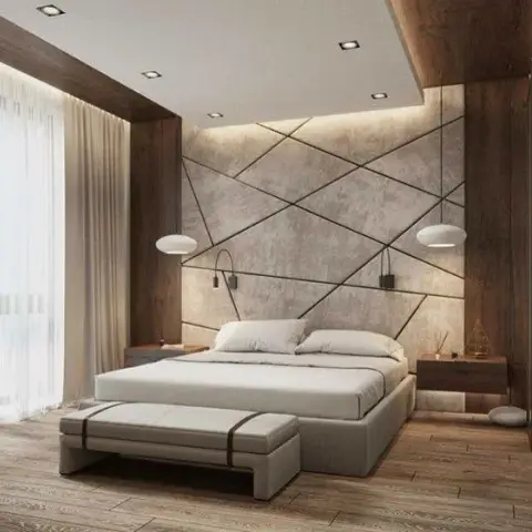 Master bedroom with a geometric textured plaster accent wall flanked by wood cladding, twin pendant lights, and a footboard bench.