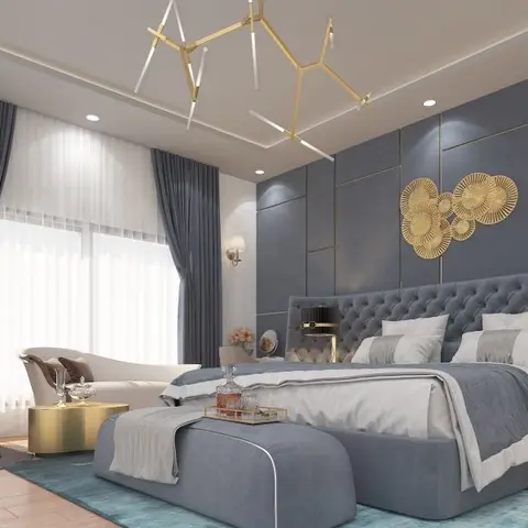 Master bedroom with a gold-trimmed blue velvet channel-tufted headboard wall, a circular gold sunburst wall sculpture