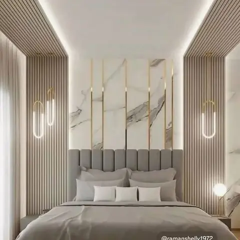 Master bedroom with a marble and brass-strip inlay headboard wall flanked by fluted wood panelling and slim vertical LED wall lights