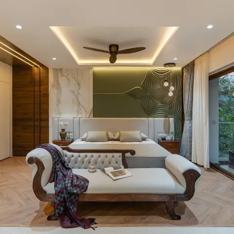 Master bedroom with a marble-and-textured olive accent wall behind the bed, a carved wood chaise lounge at the foot