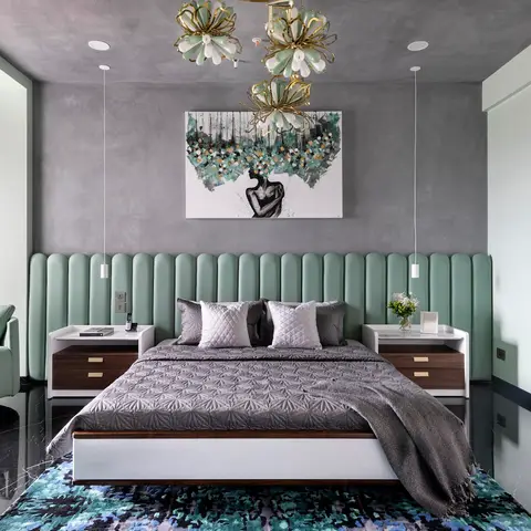 Master bedroom with a sage-green channel-tufted headboard wall and a gold floral chandelier cluster over the bed, on glossy black marble flooring