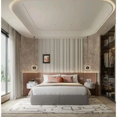 Master bedroom with a sculptural curved cove ceiling, a blush upholstered headboard, twin pendant lights and a glass-fronted walk-in wardrobe.