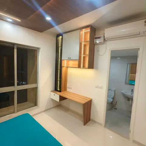 Master bedroom with a walnut wood-panelled ceiling, a backlit wall-mounted study/dressing unit with open cubbies