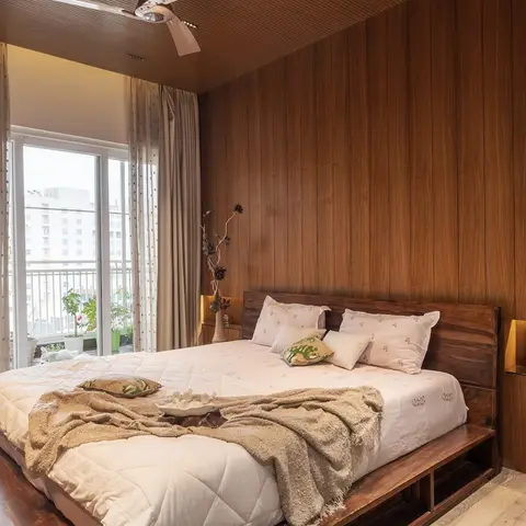 Master bedroom with full-height walnut wall panelling and matching wood-slat ceiling, a solid wood platform bed with storage drawers