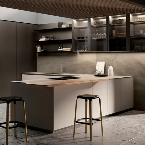 Minimalist designer kitchen with a terrazzo floor, wood-slat ceiling, backlit glass display cabinets, and a waterfall island with a curved wood breakfast bar.