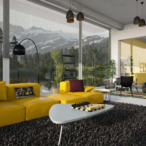 Mustard modular sofa and matching ottoman on a charcoal shag rug, facing floor-to-ceiling glazing with integral venetian blinds over a lake and pine forest