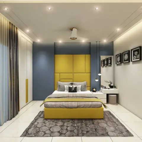 Mustard upholstered block-panel headboard running full height against a slate-blue niche wall