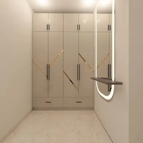 Narrow entry lobby with a full-height ivory shoe cabinet inlaid with thin brass zigzag strips