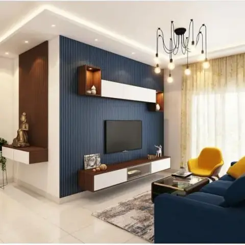 Navy fluted TV wall with a walnut-and-white floating console and two lit display boxes