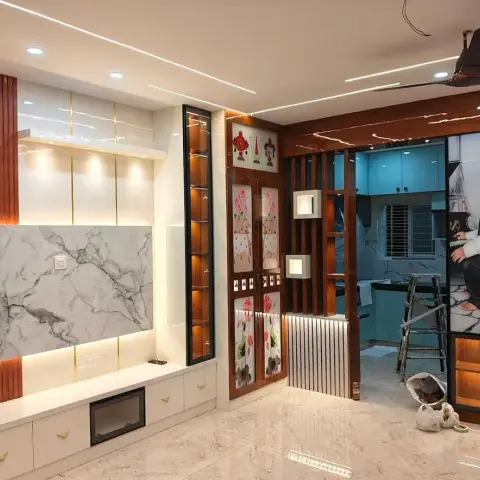 Near-complete living wall with a book-matched marble TV panel between rosewood flutes and a lit glass curio column