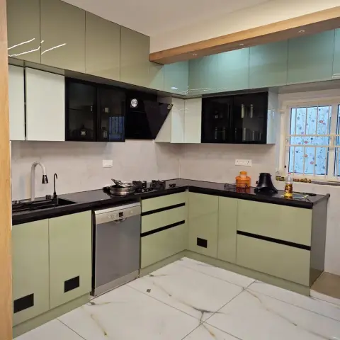 New U-shaped kitchen in sage-green high-gloss shutters with black-glass upper cabinets, black granite counters