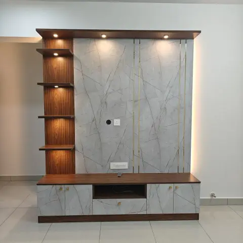 Newly built TV unit standing alone in an empty tiled room: grey marble-laminate back panel with thin brass inlay strips