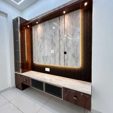 Newly built TV wall in an otherwise bare room: a high-gloss rosewood-laminate frame around a beige marble-laminate back panel