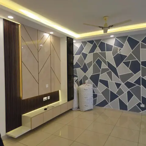 Newly finished living room with a geometric navy-and-grey wallpaper feature wall, a gold-inlaid chevron TV panel with fluted wood strip