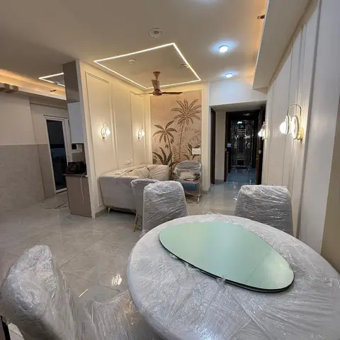 Newly finished open-plan living-and-dining space with furniture still under protective wrap