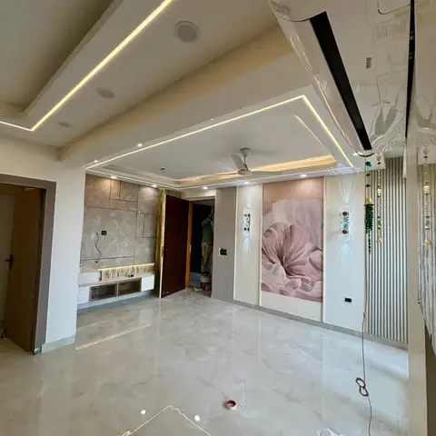 Newly finished, still-unfurnished living room with a stepped cove-lit ceiling, glossy marble-finish flooring