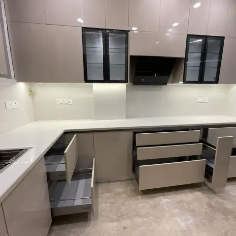 Newly installed L-shaped kitchen photographed with every drawer bank pulled open on its tandem boxes