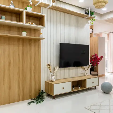 Oak-and-white living room where a white fluted panel carries the TV over a legged oak console with two white drawers