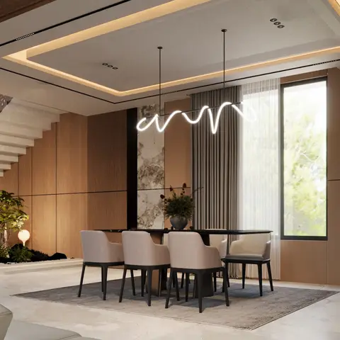 Open dining area with a black table and blush upholstered chairs beneath a sculptural wavy pendant light, a marble-clad feature wall