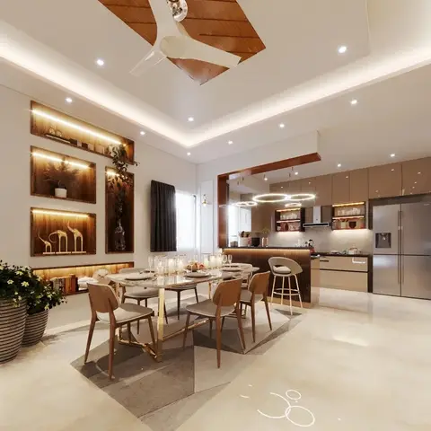 Open dining area with a gold-framed dining table in front of an L-shaped kitchen, lit wall display niches, and a cove-lit ceiling with a wood-clad fan surround.