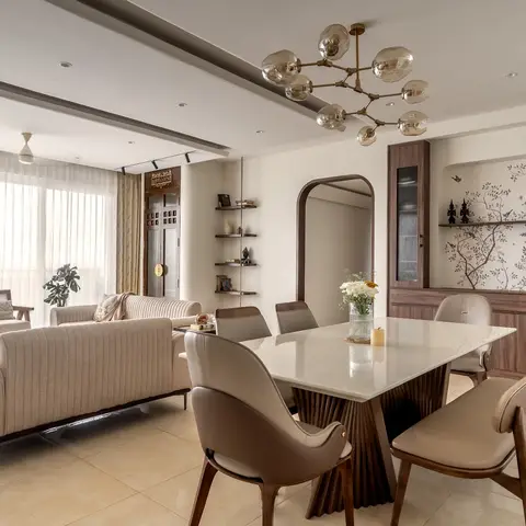Open dining area with a mid-century sputnik chandelier over a marble-top table, a walnut crockery unit inset with a bird-and-branch wallpaper mural