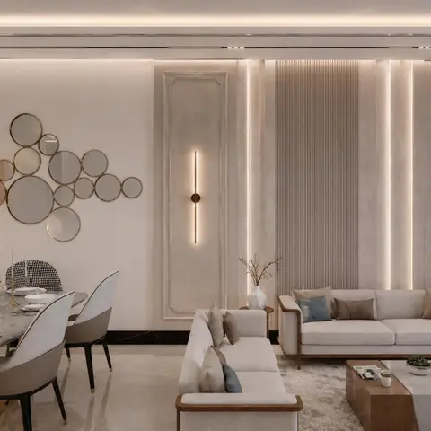 Open dining-living space with a fluted and moulded panel accent wall, linear brass wall sconces