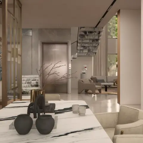 Open ground floor of a villa viewed across a black-veined white marble dining table, with a deep coffered plaster grid and a painted scroll mural on the left