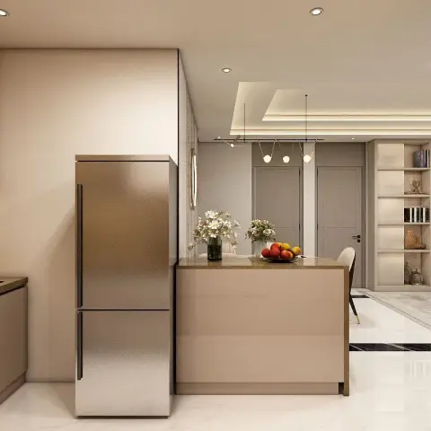 Open kitchen in beige gloss shutters with a peninsula counter jutting toward the dining zone, a free-standing steel fridge boxed into the tall run