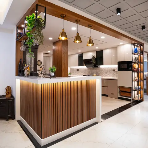 Open kitchen with a fluted-wood breakfast counter, three brass pendant lights, a coffered grid ceiling, patterned tile backsplash