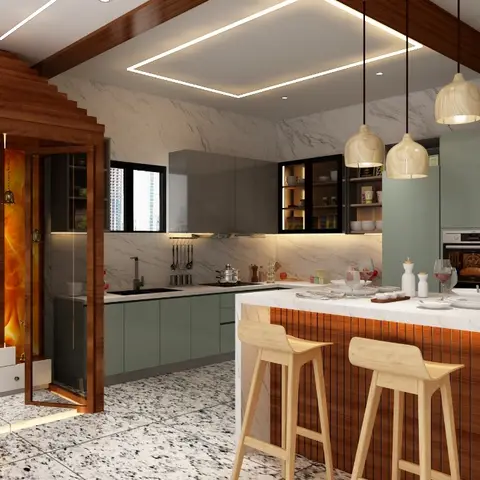 Open kitchen with sage-green cabinetry, a marble waterfall-edge island with bar seating, and an adjoining wood-framed backlit pooja alcove.