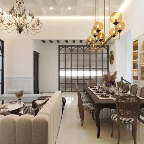 Open living-dining render where a crystal-and-brass chandelier hangs over a boucle sofa set on one side and a brass globe linear fixture over an eight-seat