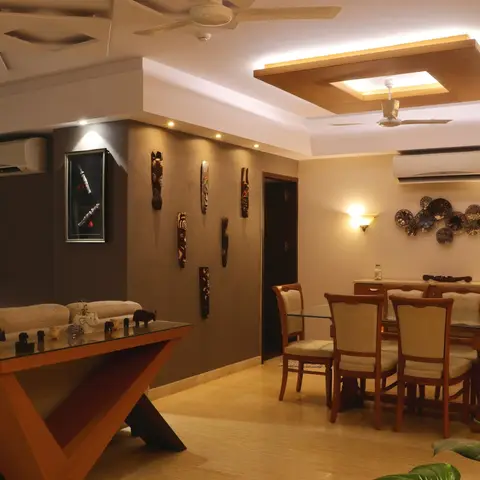 Open living-dining space with an elaborate wood-clad pop ceiling, a tribal wooden mask display wall