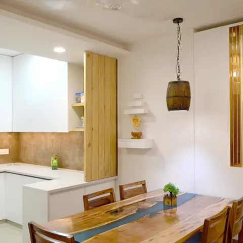 Open-plan dining and kitchen with a live-edge blue-resin wood dining table under a barrel-shaped pendant light