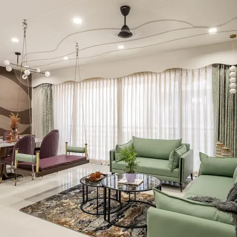 Open-plan dining and living area with a wave-contoured cove ceiling, a burgundy leather hanging swing bridging a purple velvet dining set and sage-green sofas