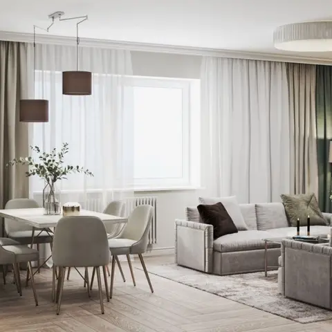 Open-plan dining and living space with a six-seat dining table under twin drum pendants, layered sheer-and-green curtains