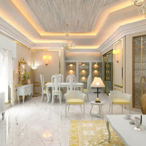Open-plan gold-trimmed living and dining space with a carved white-and-gold dining set, a yellow sofa, and a CNC-jaali gold room divider