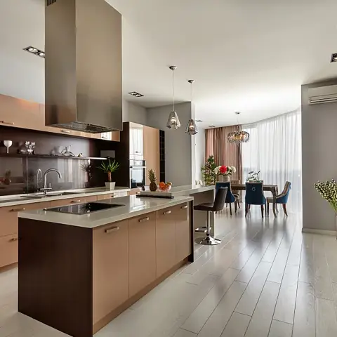 Open-plan kitchen, dining and living space with a two-tone wood kitchen island, glass pendant lights, a dining table with mixed upholstered chairs