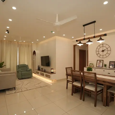 Open-plan living and dining room with a fluted TV feature wall, a three-pendant light over the wood dining table