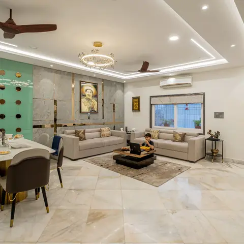 Open-plan living and dining space with a mint-green mirrored-disc feature wall over the dining table and a grey marble gold-inlay feature wall behind twin