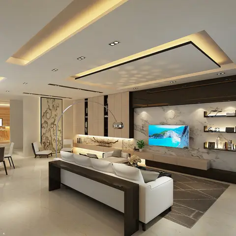 Open-plan living area with a full-height marble TV wall, a floating oak console, and a dark-framed white sofa under a stepped cove-lit ceiling.