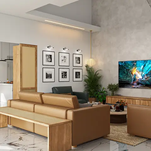 Open-plan living area with twin caramel-leather sofas facing a wall-mounted TV, a six-photo gallery wall