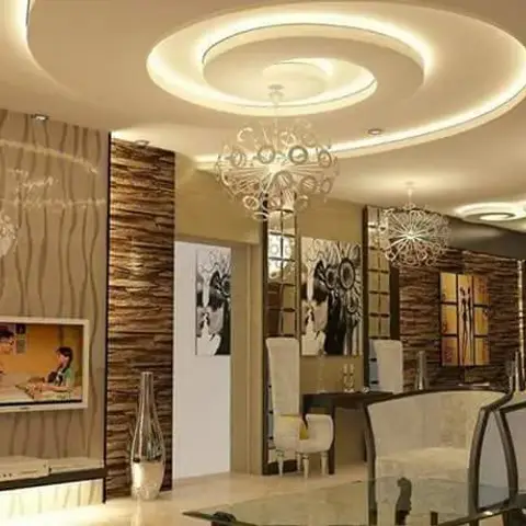 Open-plan living-dining area with an elaborate spiral POP ceiling and cove lighting, multiple decorative pendant lights, a stone-clad accent wall