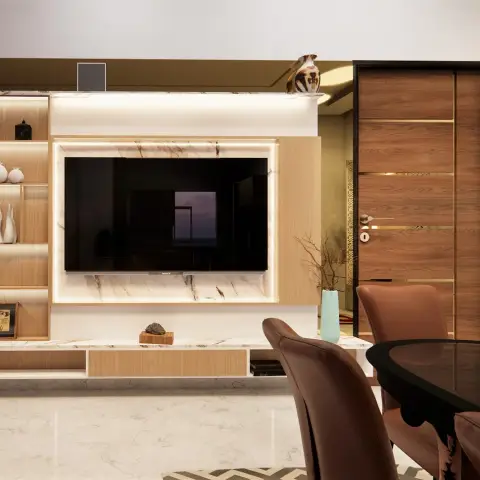 Open-plan living-dining corner with a marble-backed, backlit TV wall unit and open display shelving beside a leather-chair dining table and a brass-inlaid wood