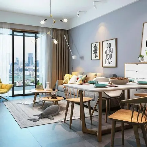 Open-plan living-dining room with a mustard armchair, a light-oak dining table and Windsor-style chairs, a gallery wall