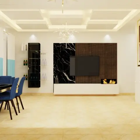 Open-plan living-dining with a black-marble and fluted-wood TV feature wall under a coffered cove-lit ceiling, gold-legged dining table with navy chairs