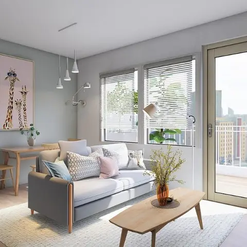 Open-plan studio apartment render showing a kitchenette, a small dining table, and a living area sofa with a balcony door, all in one frame.