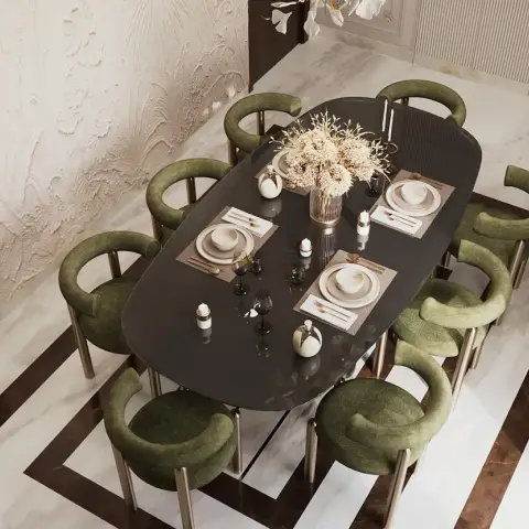 Overhead shot of an oval dark-lacquer dining table set for four, ringed by eight olive-green velvet tub chairs on slim brass legs