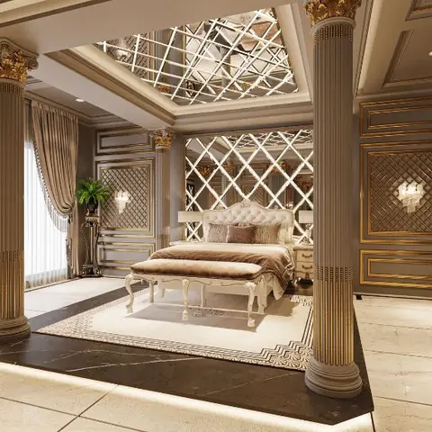 Palatial bedroom with gold-capped classical columns framing a tufted white upholstered bed against a diamond-lattice mirrored headboard wall